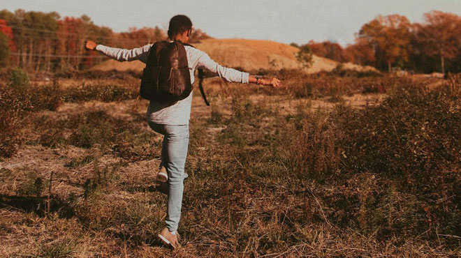 Male Instagram Influencer Skipping Through a Field